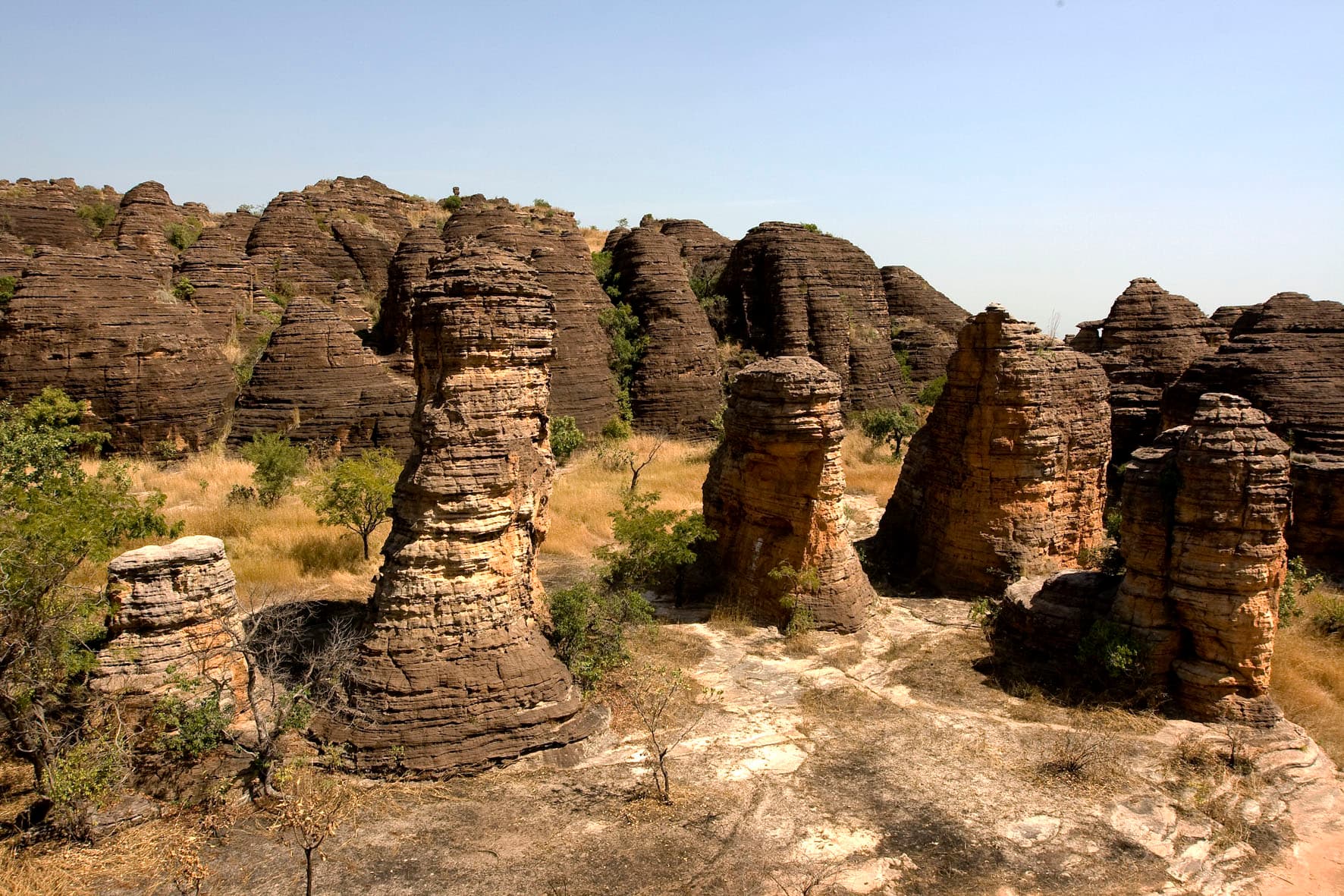 Rounded granite domes of Fabedougou rising above green savanna