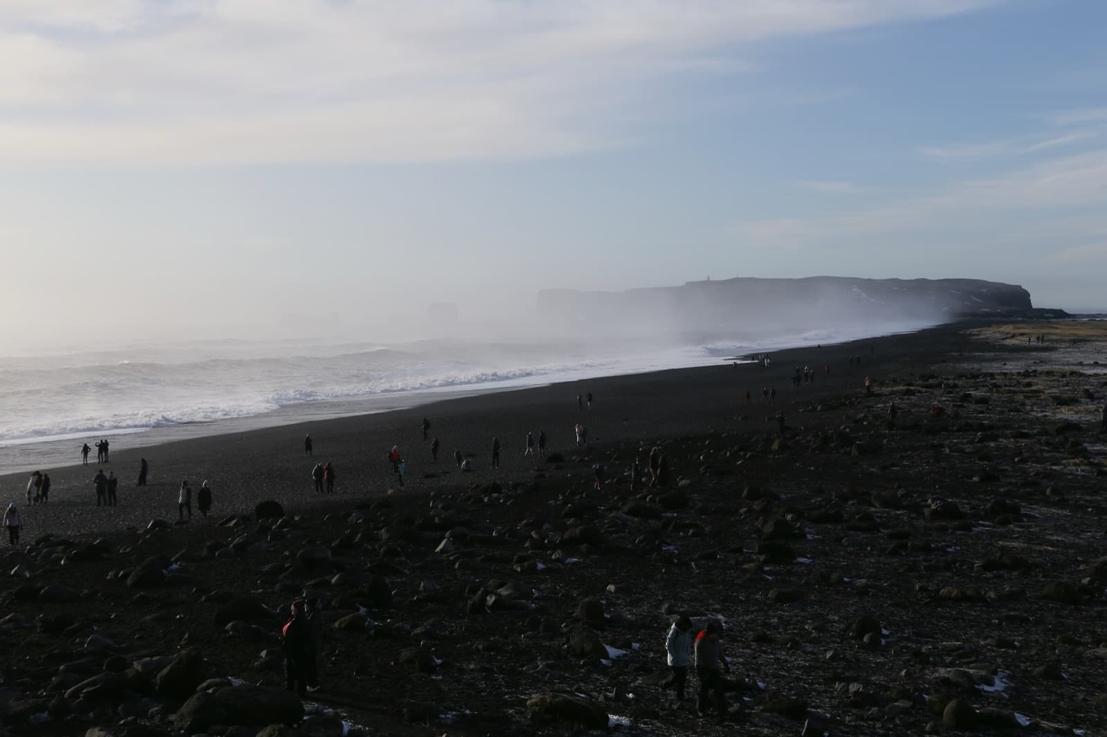 Reynisfjara black sand beach near V铆k with basalt sea stacks rising from the waves