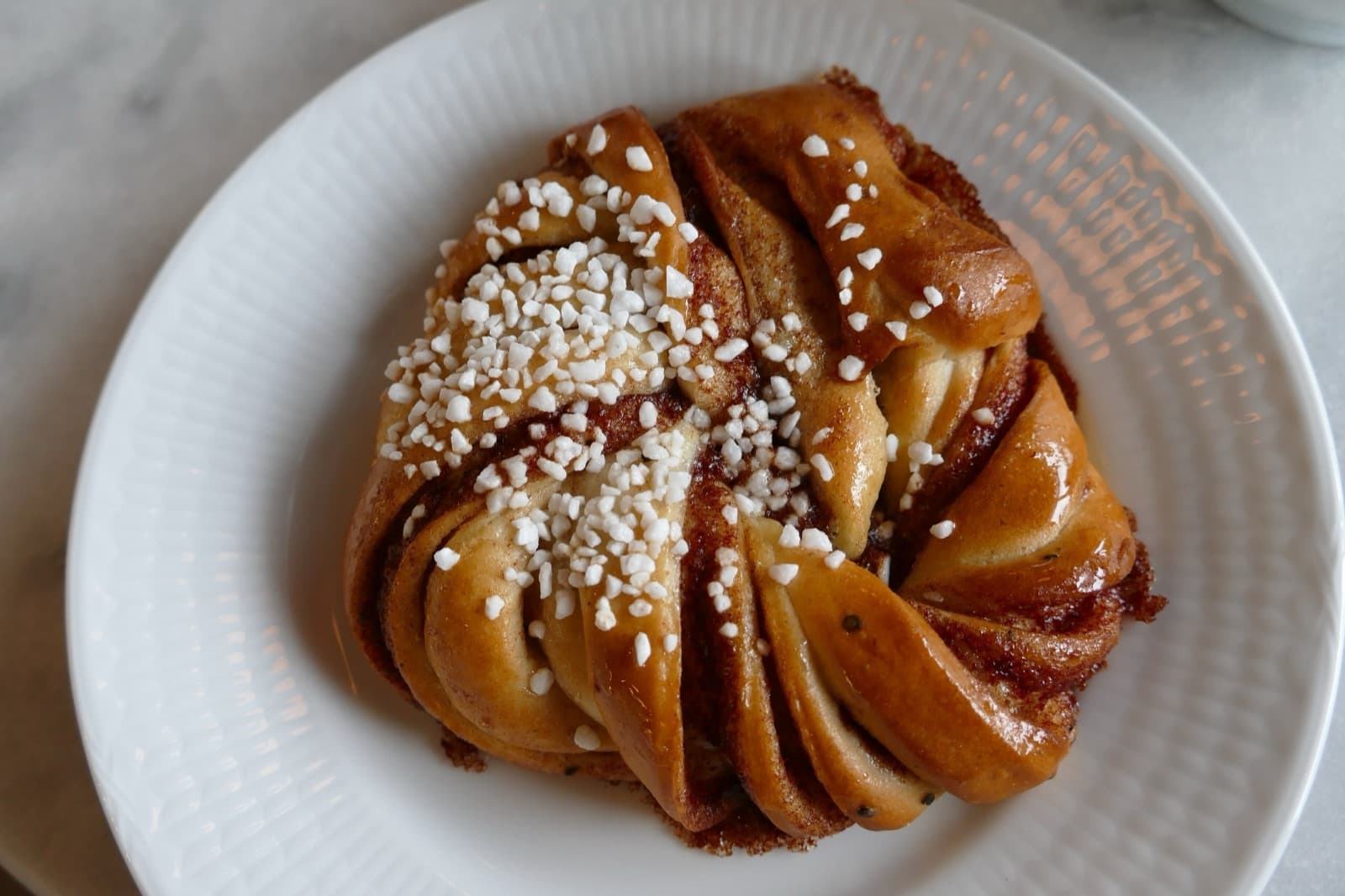 Freshly baked Norwegian cinnamon buns (kanelboller) on a wooden board