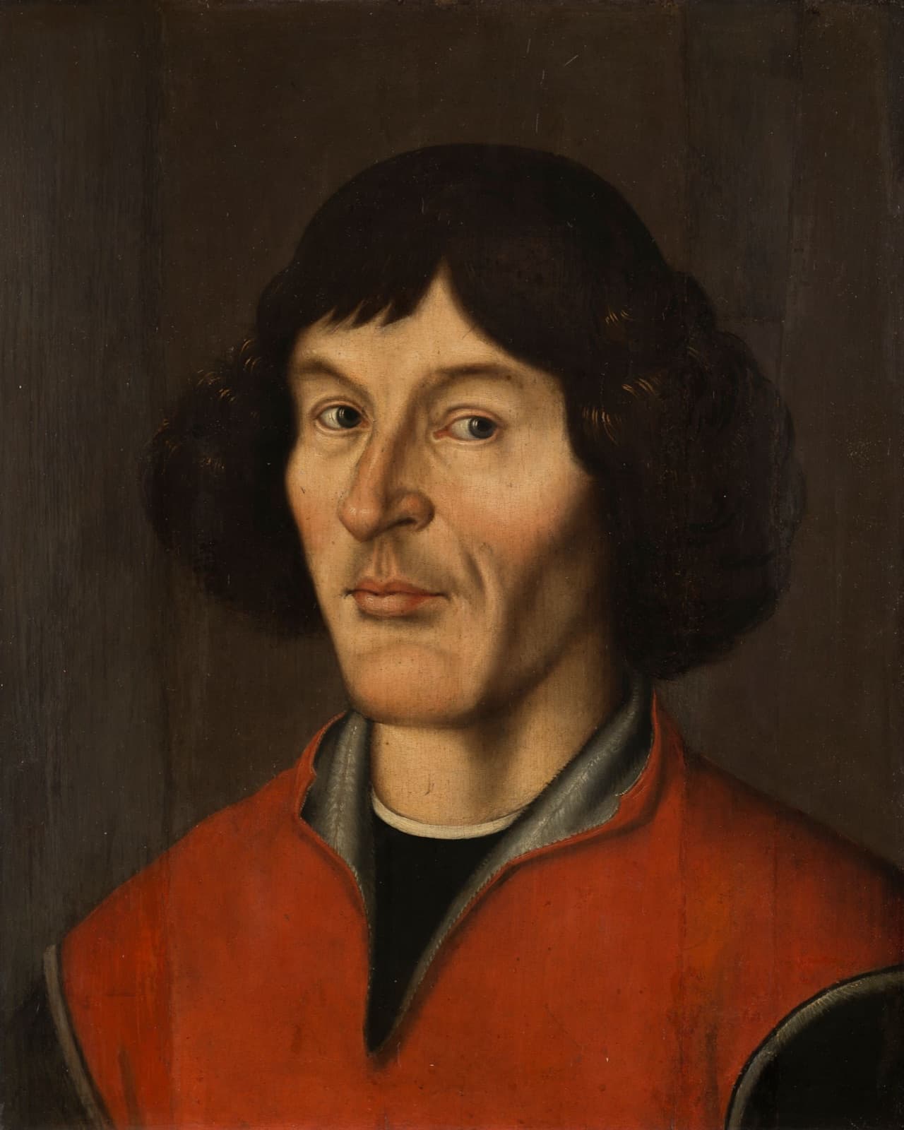 A statue of Copernicus holding a model of the solar system, in Toru艅